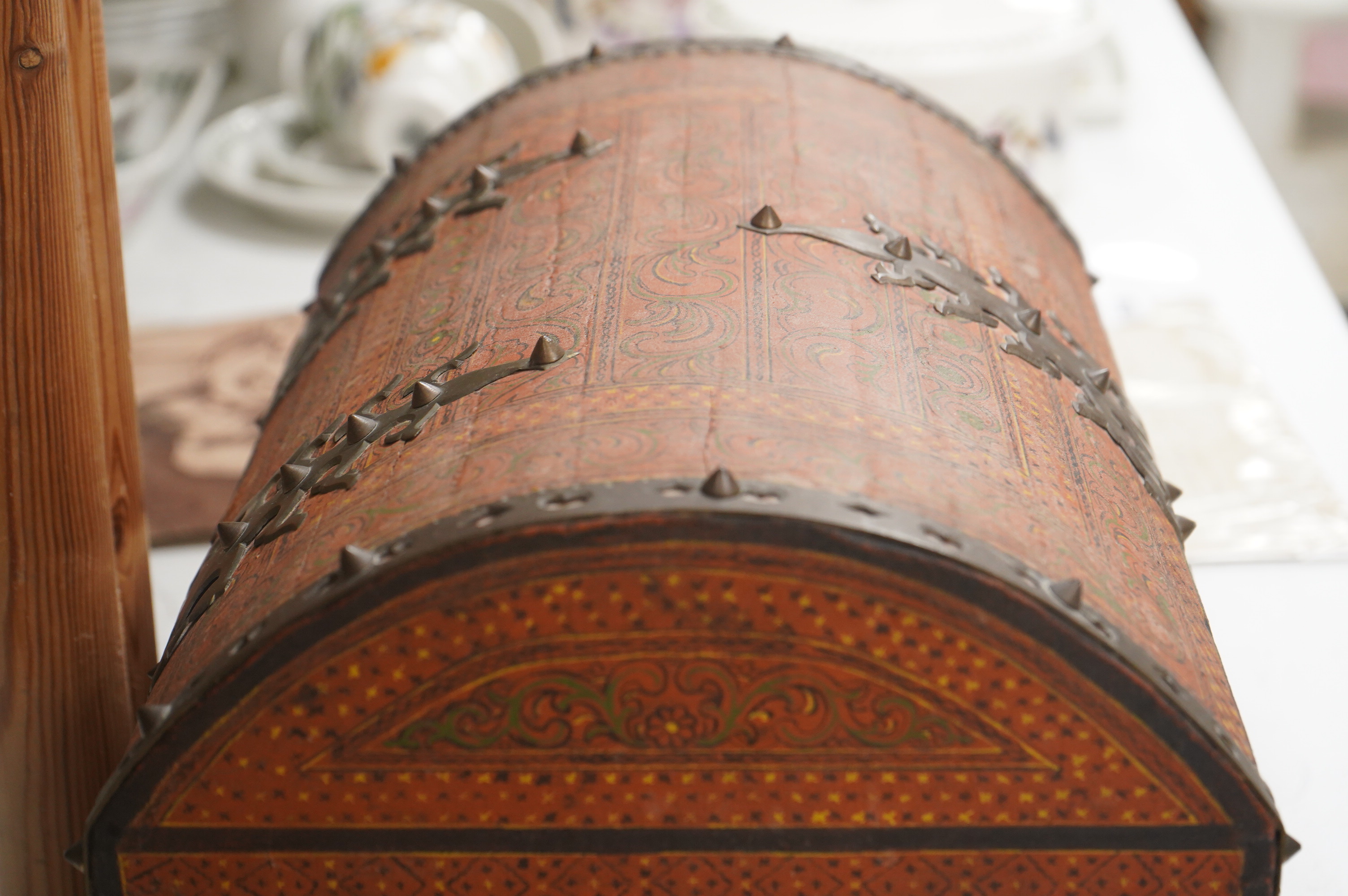 A Tibetan brass mounted painted wood dome casket, 36cm wide